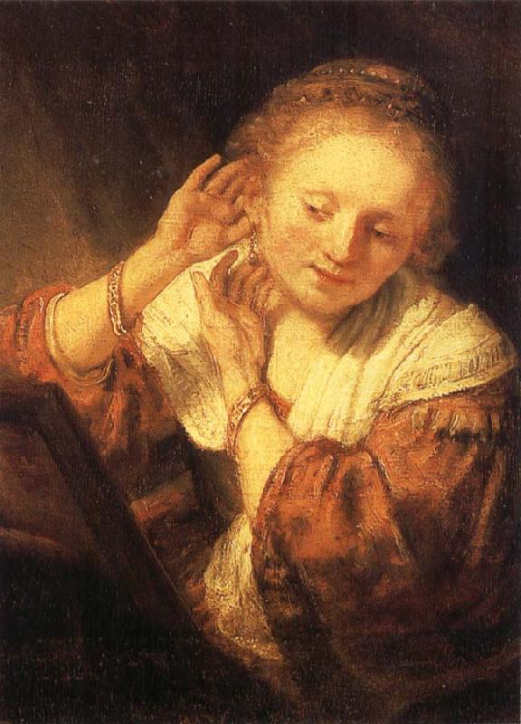 REMBRANDT Harmenszoon van Rijn Young Woman Trying on Earrings oil painting picture